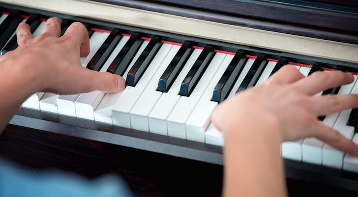 Fingers on piano keys